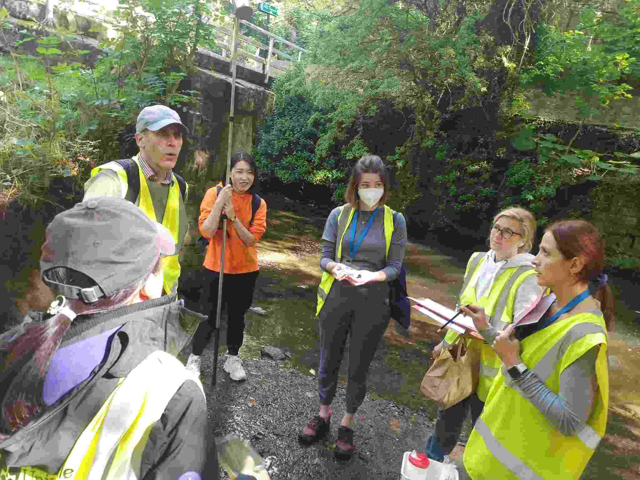 Workshop participants, wearing high vis jackets, conducting field work on the river Ouseburn